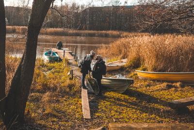 A young couple on a pier in a autumn setting.